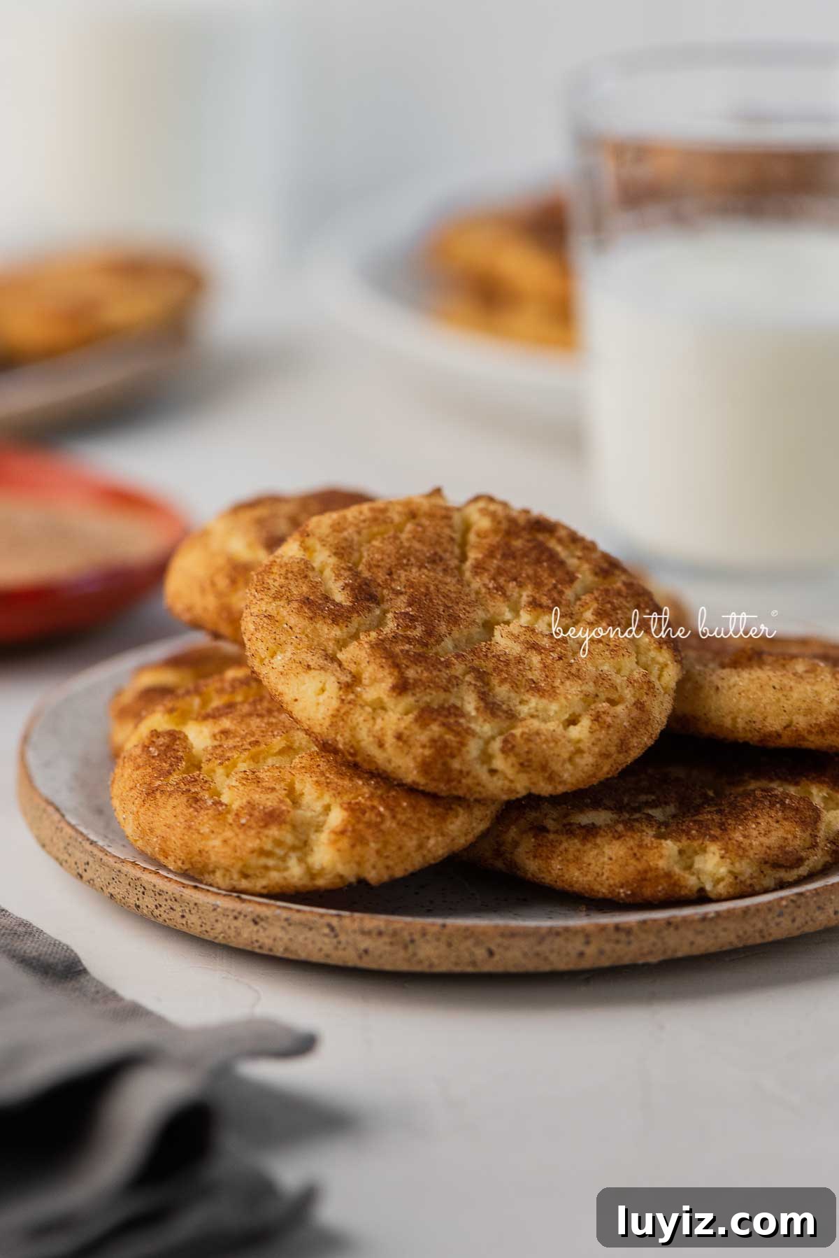Classic Snickerdoodle Cookie Recipe: Soft Cinnamon Sugar Cookies 7 Snickerdoodle cookies on a parchment paper lined baking sheet | © Beyond the Butter®