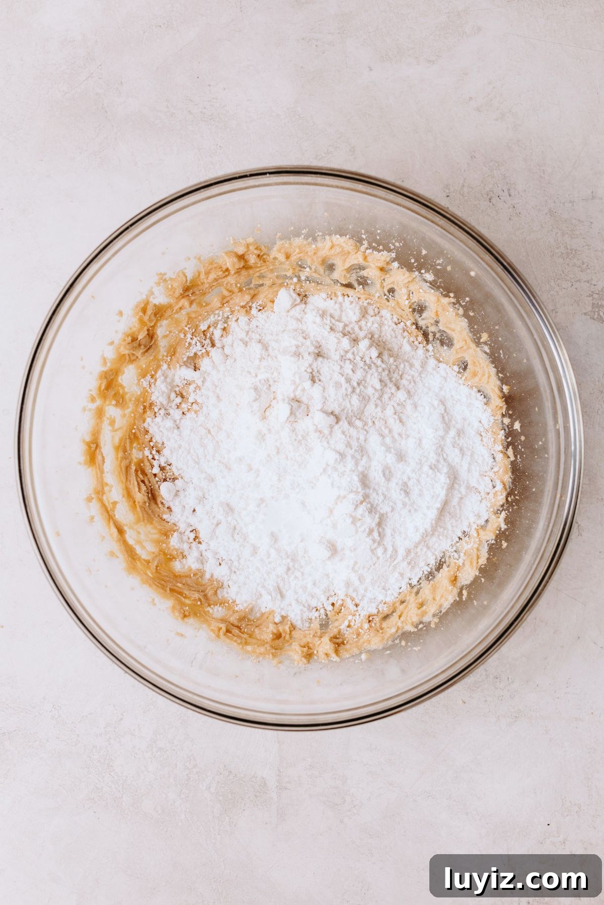 Chocolate Chip Cookie Dough Cupcakes Recipe with Gooey Centers 15 Heat treated all purpose flour, powdered sugar, and salt added to cookie dough buttercream mixture in a large glass mixing bowl.