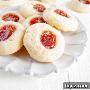 Holiday Jamboree Cookie Recipes for Festive Baking 9 Holiday jamboree cookies on a ceramic dessert plate on a white wood background.