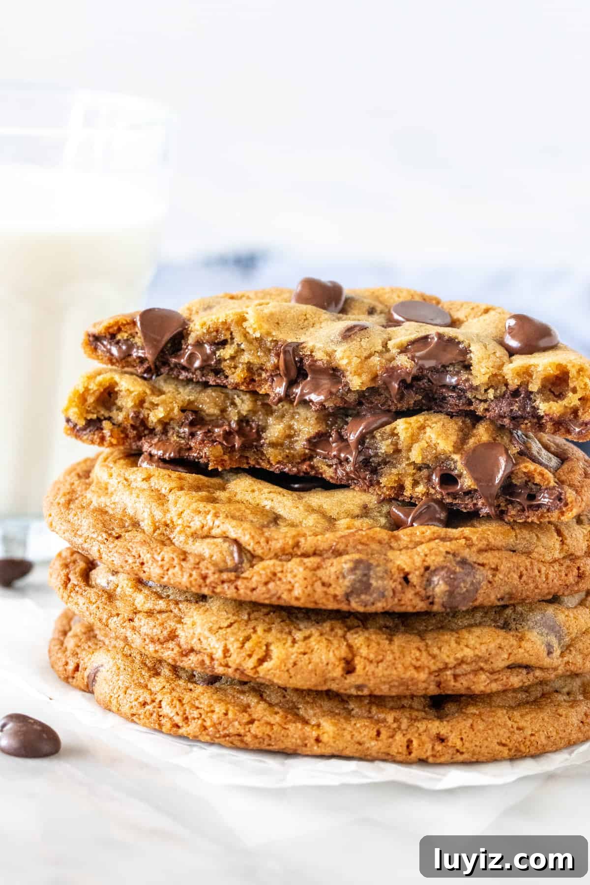 Bakery-Style Chocolate Chip Cookies: Soft, Chewy, and Irresistible 2 Stack of bakery chocolate chip cookies with top cookie broken in half