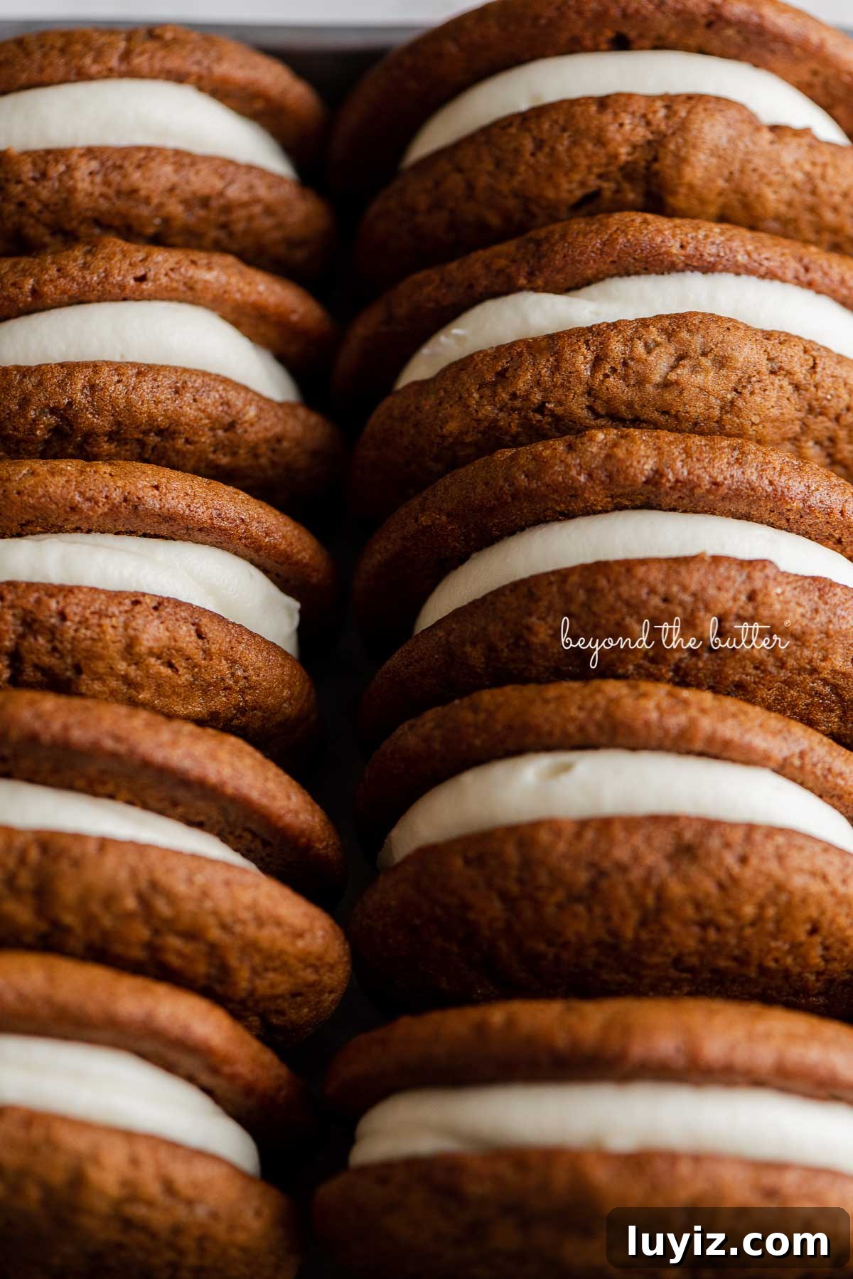 Gingerbread Whoopie Pies Recipe: Soft Molasses Sandwich Cookies 15 Stacked gingerbread whoopie pies | © Beyond the Butter®