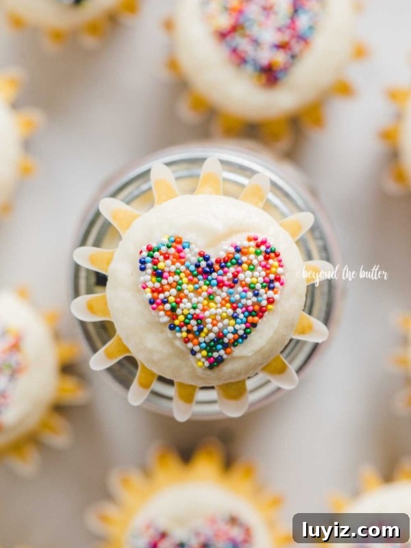 DIY Gingerbread Houses: Step-by-Step Guide for Festive Creations 9 Overhead image of sprinkled heart cupcakes on white background with center cupcake on top of jar.