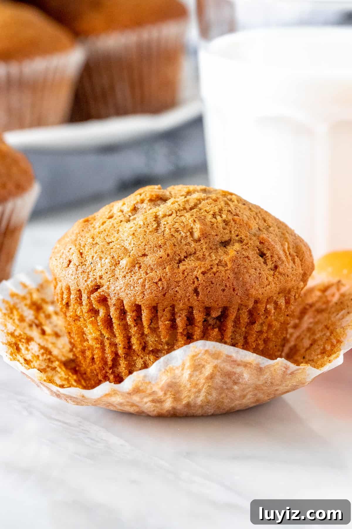Moist Carrot Cake Muffins with Cream Cheese Frosting 2 Carrot cake muffin with a glass of milk