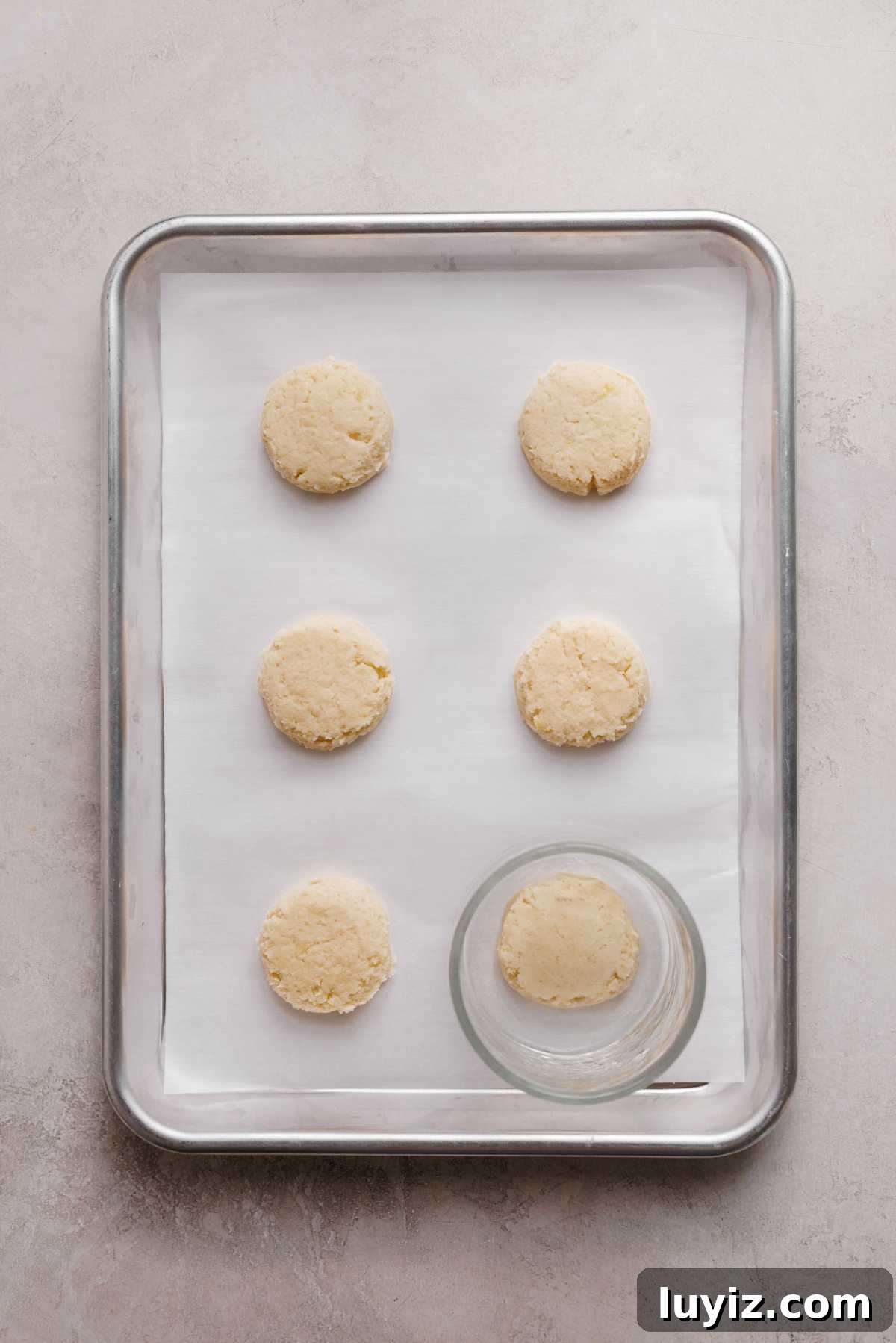 Zesty Lemon Shortbread Cookies: Crispy, Buttery Citrus Treats 10 Lemon shortbread cookie dough with flattened tops using the bottom of a glass bowl.