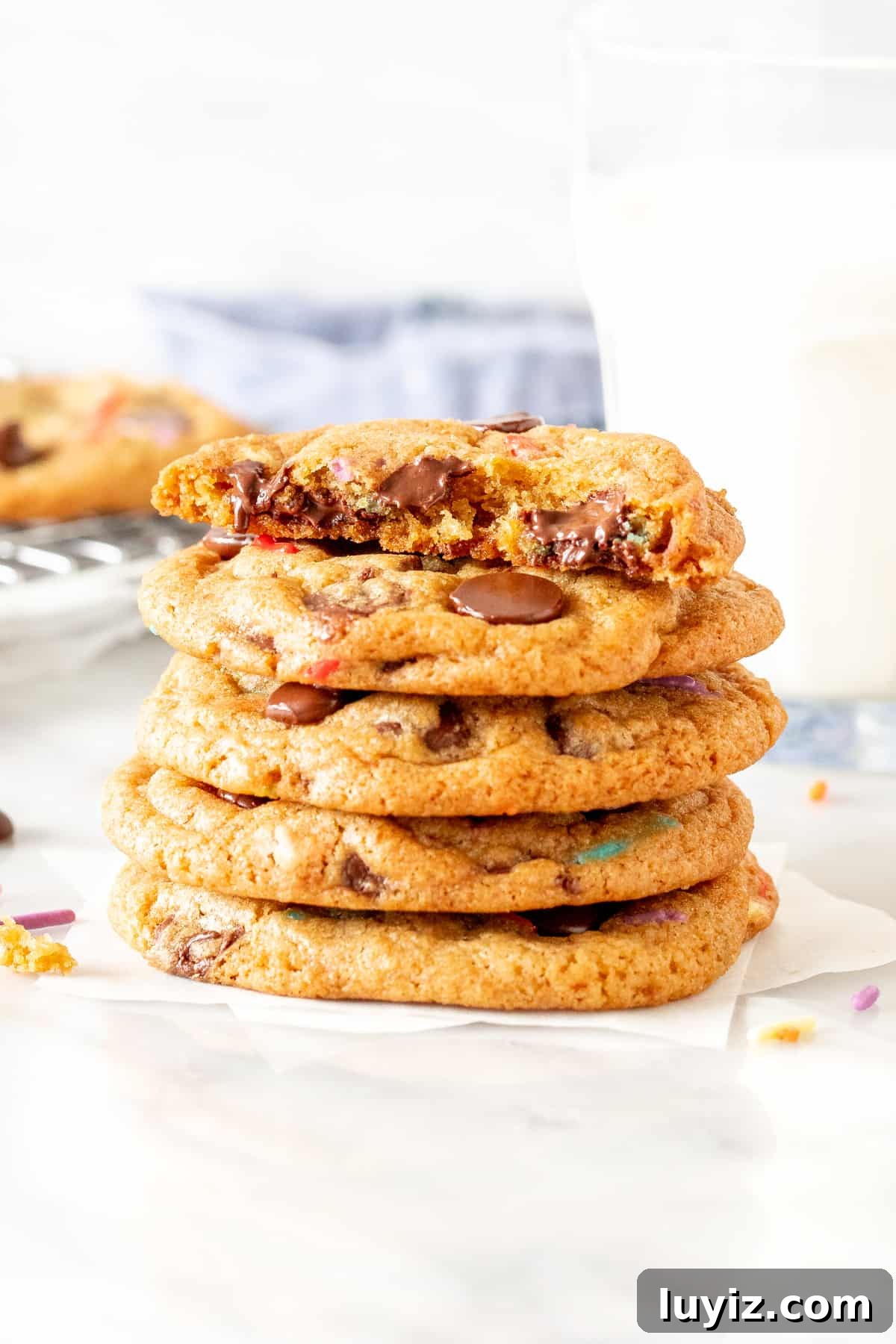Sprinkled Chocolate Chip Cookies: Soft, Chewy, and Irresistible 4 Stack of birthday chocolate chip cookies, with top cookie broken in half