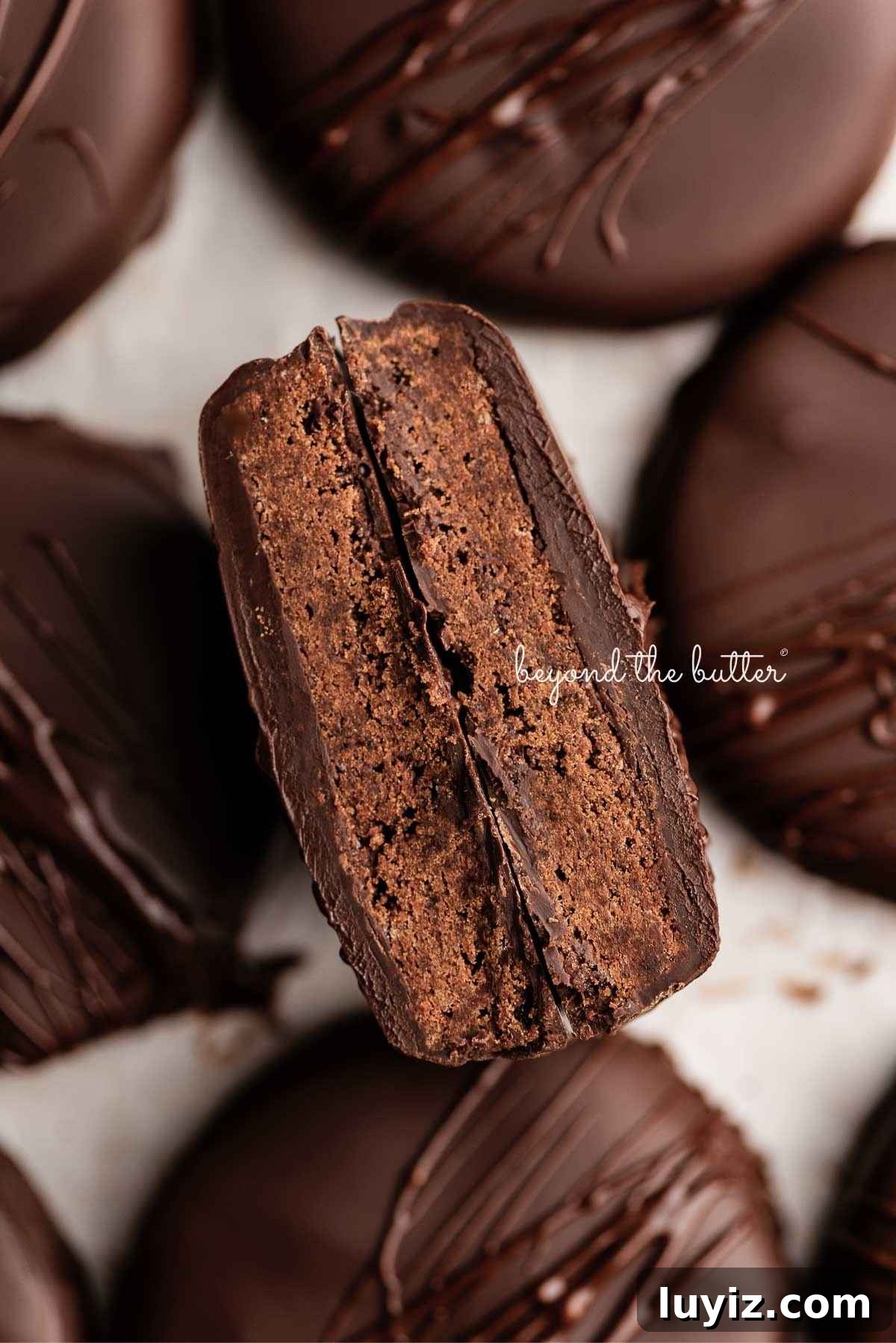 Homemade Thin Mints Recipe: Crisp Chocolate Mint Cookies 13 Homemade thin mints on a wax paper lined baking sheet with center cookie cut in half.