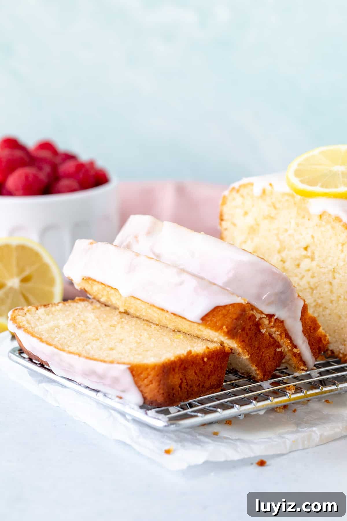 Super Moist Lemon Loaf with Bright Glaze 5 Sliced lemon loaf on a wire cooling rack