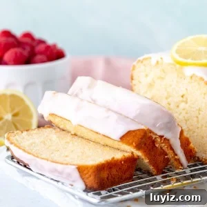 Super Moist Lemon Loaf with Bright Glaze 7 Sliced lemon loaf on a wire cooling rack