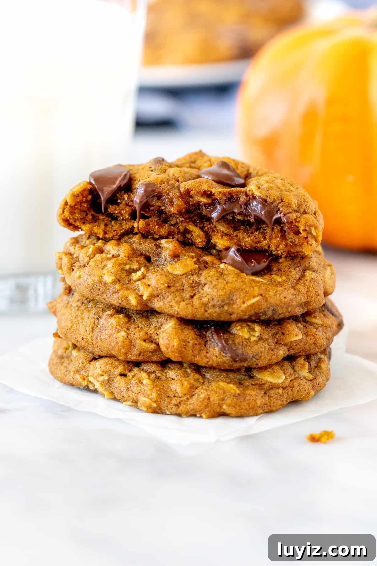 Chocolate Chip Pumpkin Oatmeal Cookies Recipe That Impresses 5 Stack of pumpkin chocolate chip oatmeal cookies with a glass of milk.