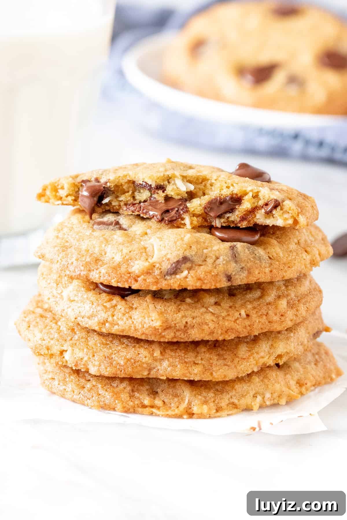 Chewy Coconut Chocolate Chip Cookies Recipe for Home Bakers 4 Stack of coconut chocolate chip cookies with a glass of milk