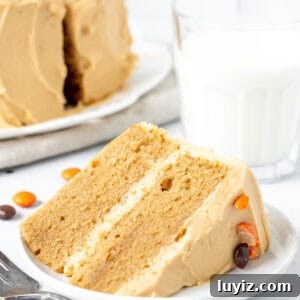 Decadent Peanut Butter Layer Cake Recipe 9 Slice of peanut butter cake on its side with glass of milk