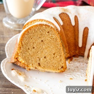 Moist Eggnog Bundt Cake Recipe Perfect for Christmas 6 Round eggnog bundt cake with a few slices sliced
