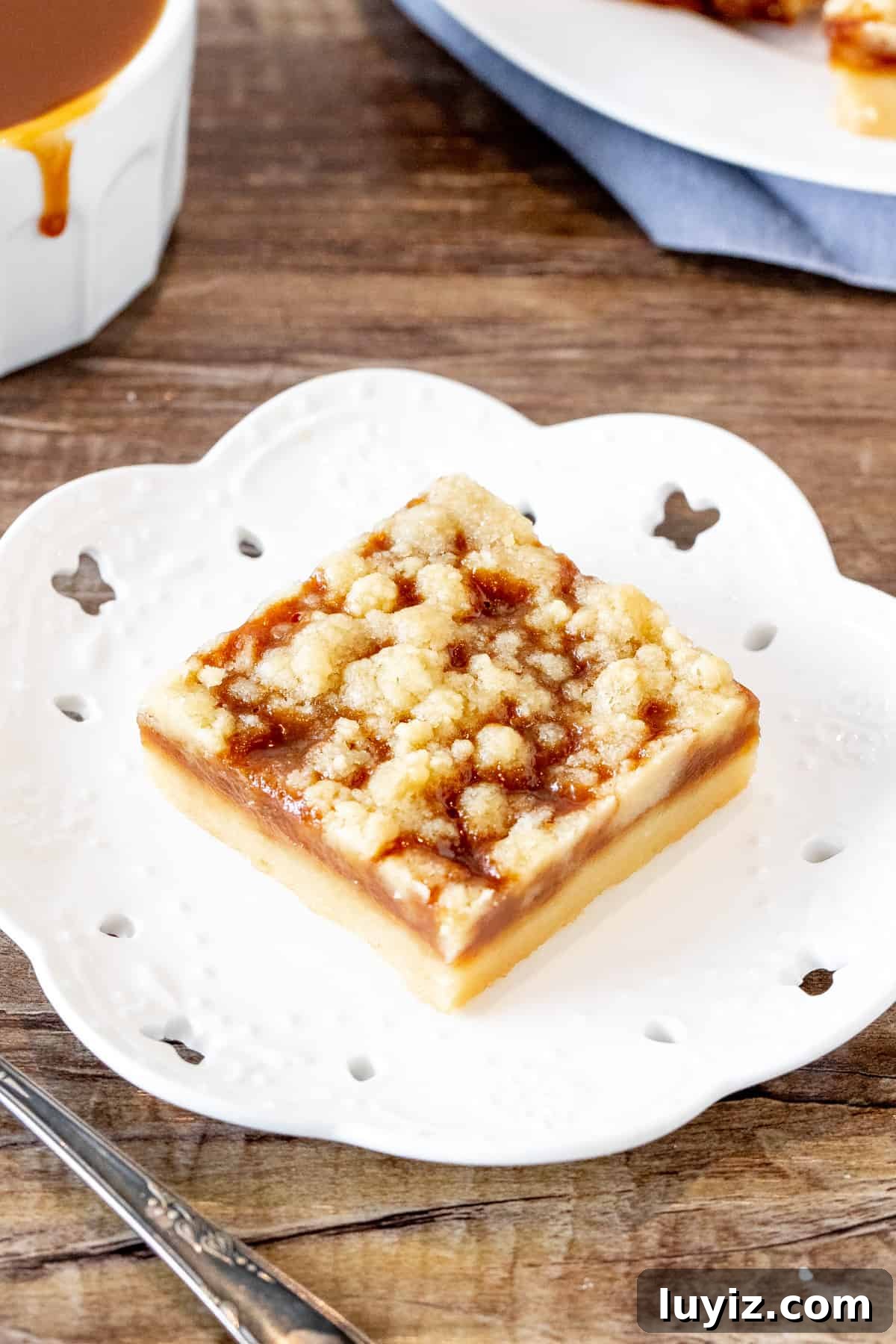 Salted Caramel Crumb Bars with Buttery Shortbread 4 Caramel crumb bar on a plate