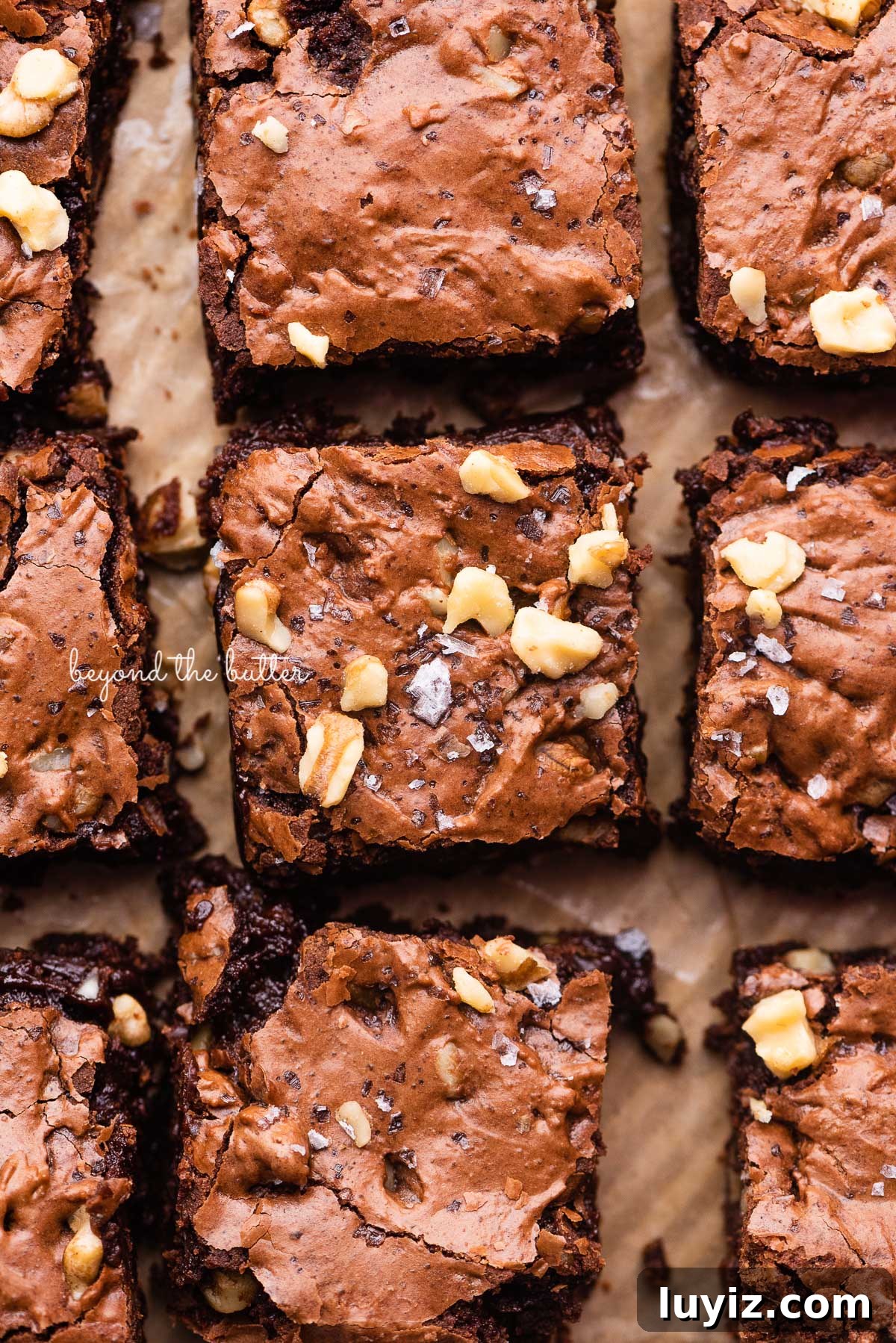 Fudgy Homemade Brownies That Beat Box Mixes 2 Better than box mix fudgy brownies on a parchment paper lined baking sheet | © Beyond the Butter®