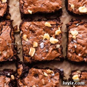 Fudgy Homemade Brownies That Beat Box Mixes 11 Better than box mix fudgy brownies on a parchment paper lined baking sheet.