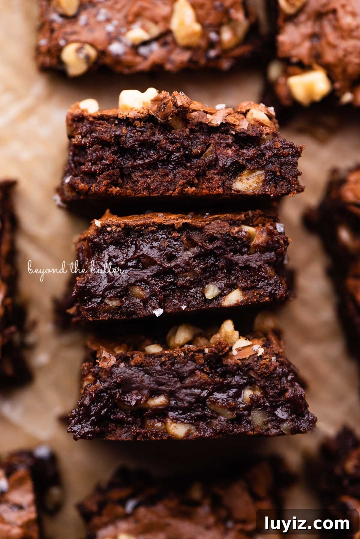 Fudgy Homemade Brownies That Beat Box Mixes 4 3 fudgy better-than-box-mix brownies on a parchment paper lined baking sheet | © Beyond the Butter®