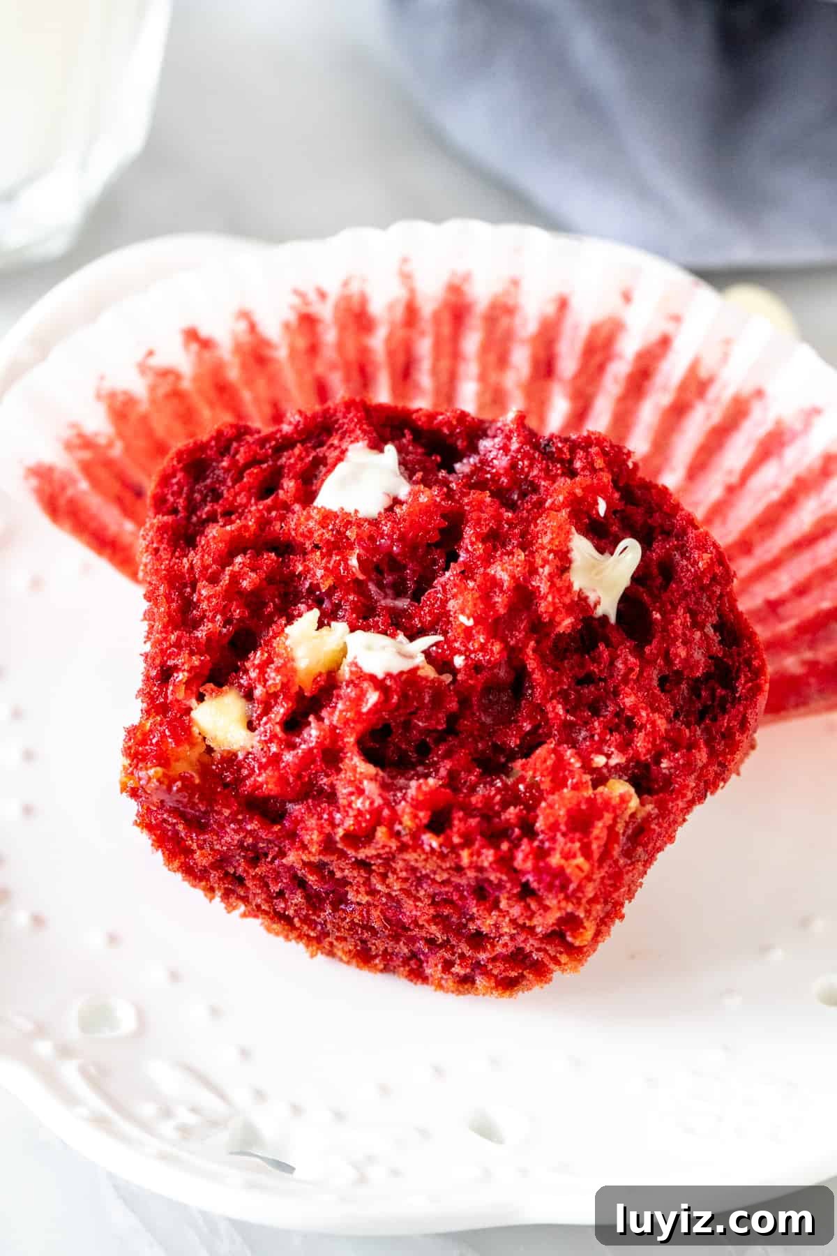 Red Velvet Muffins Stuffed with Melting Chocolate Chips 5 Half of a red velvet muffin on a plate