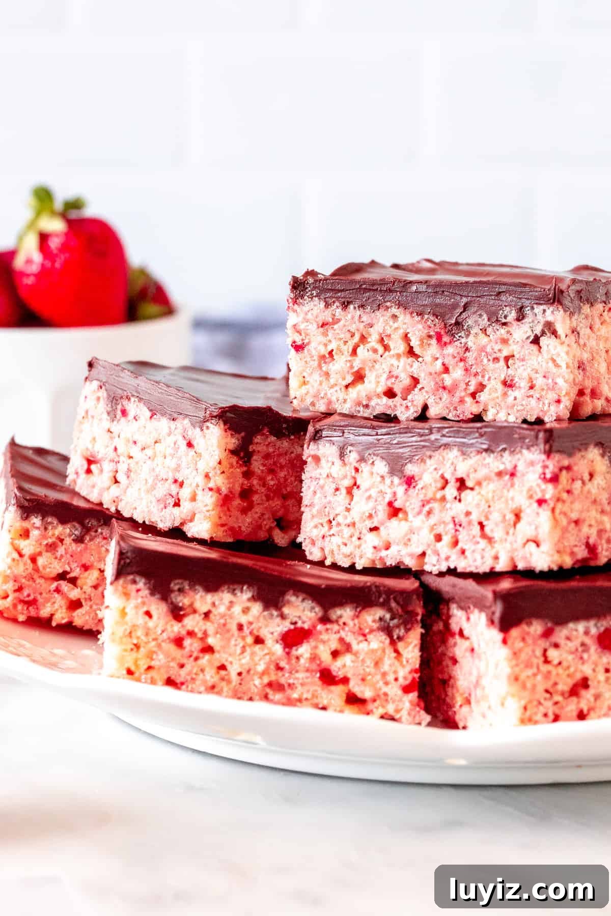 Strawberry Rice Krispie Treat Recipe: Fresh, Fruity Marshmallow Bars 5 Plate of strawberry cereal treats with chocolate topping