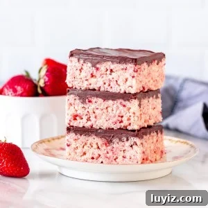 3 strawberry Rice Krispie treats with chocolate topping, stacked on top of each other