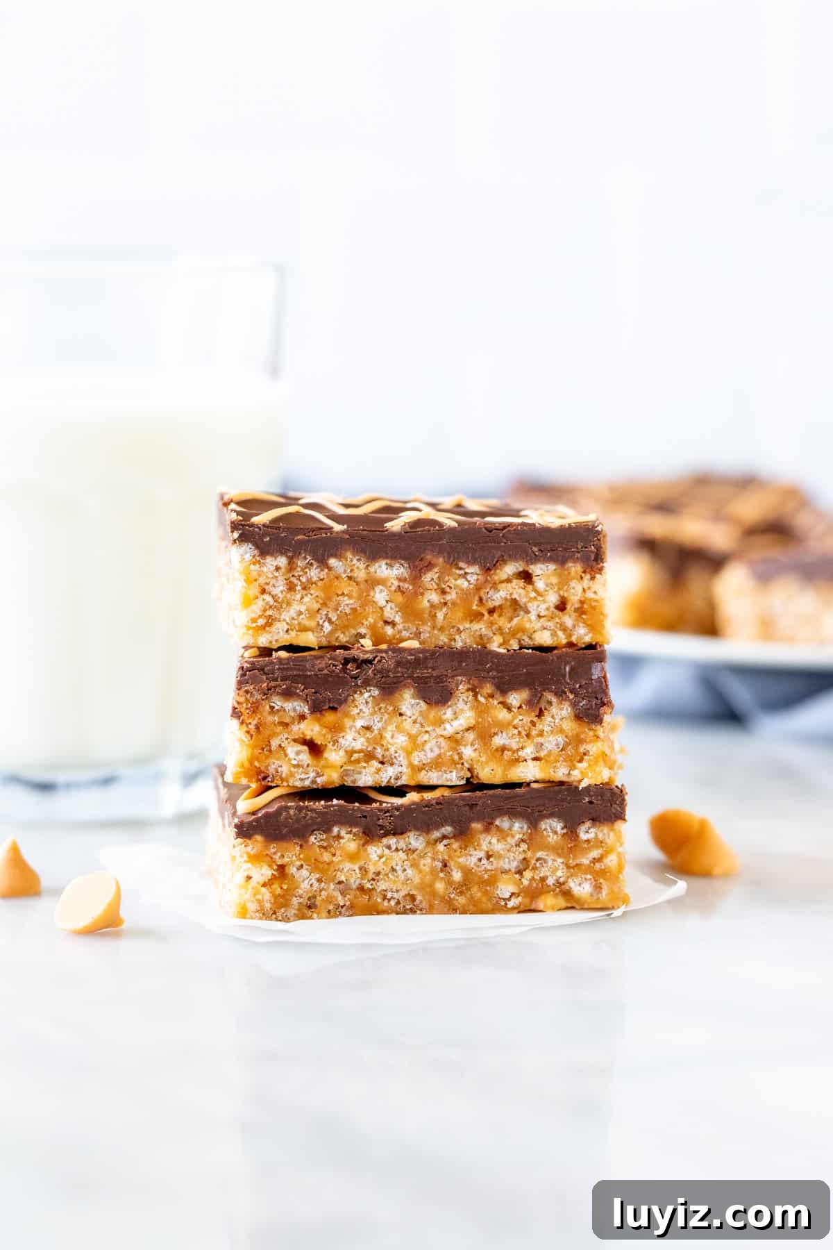 Butterscotch Tiger Bars: Crispy Rice Krispie Treats 5 3 tiger bars with chocolate topping, one on top of each other.