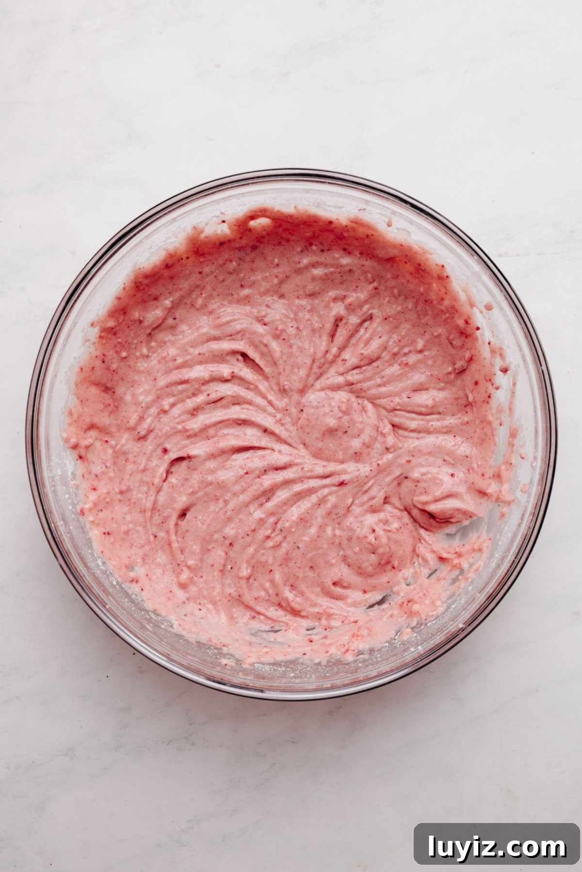 Mini Strawberry Sheet Cake Recipe: Quick Moist Fresh Strawberry Cake 13 Strawberry cake batter in a large glass mixing bowl on a white and grey textured background.