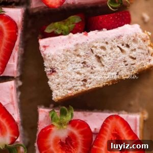 Mini Strawberry Sheet Cake Recipe: Quick Moist Fresh Strawberry Cake 21 Slices of mini strawberry sheet cake topped with strawberry buttercream frosting and fresh strawberries with one slice on its side.