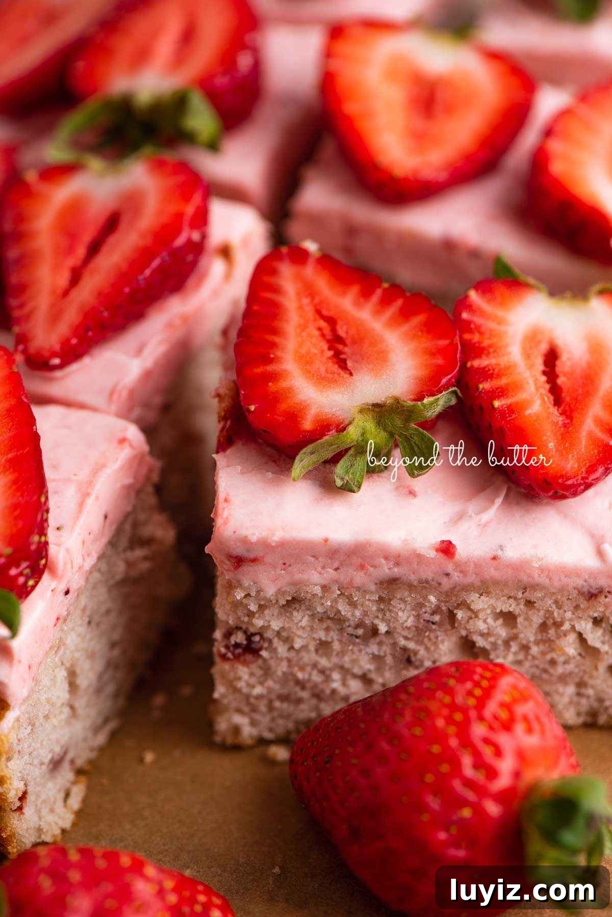 Mini Strawberry Sheet Cake Recipe: Quick Moist Fresh Strawberry Cake 5 Slices of mini strawberry sheet cake topped with strawberry buttercream frosting and fresh strawberries with one slice on its side.