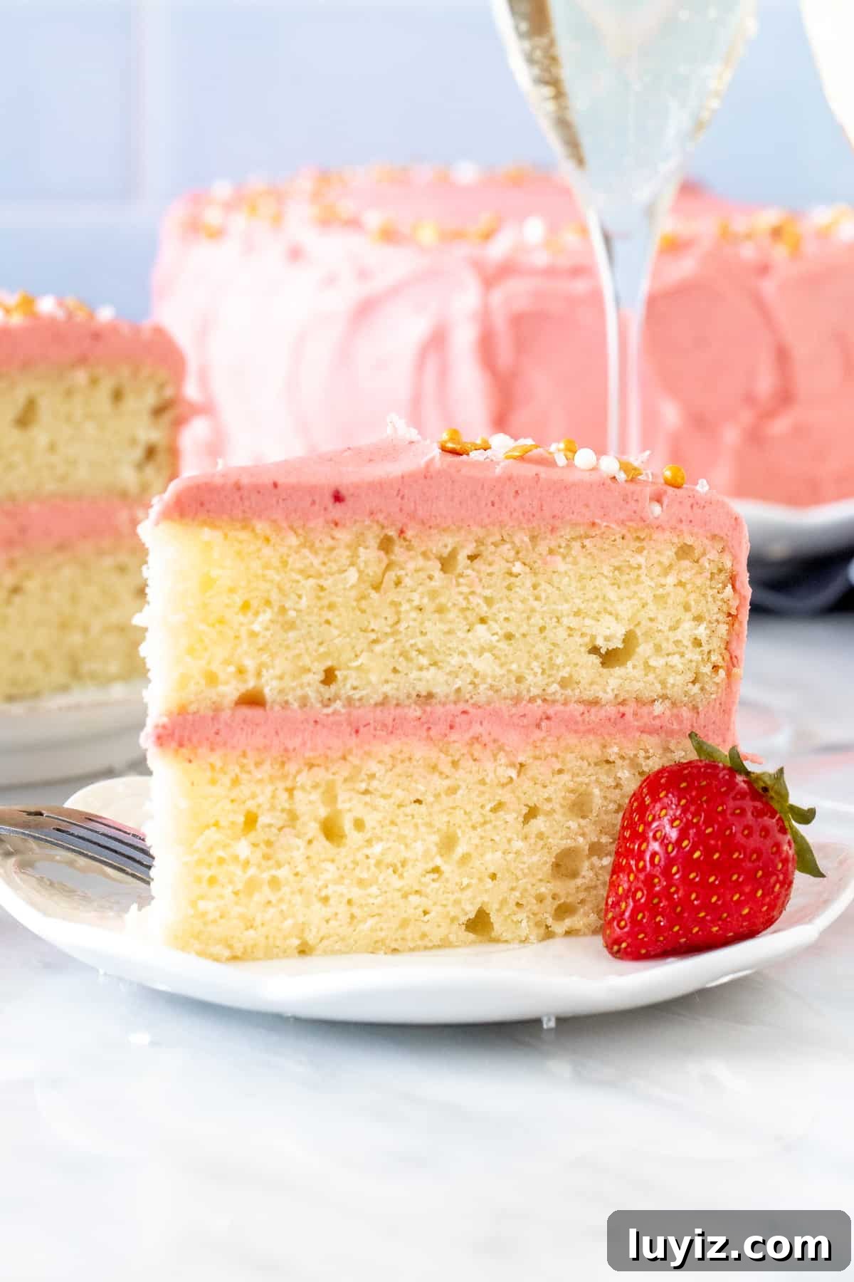 Strawberry Champagne Layer Cake Recipe for Celebrations 3 Slice of champagne layer cake with strawberry frosting