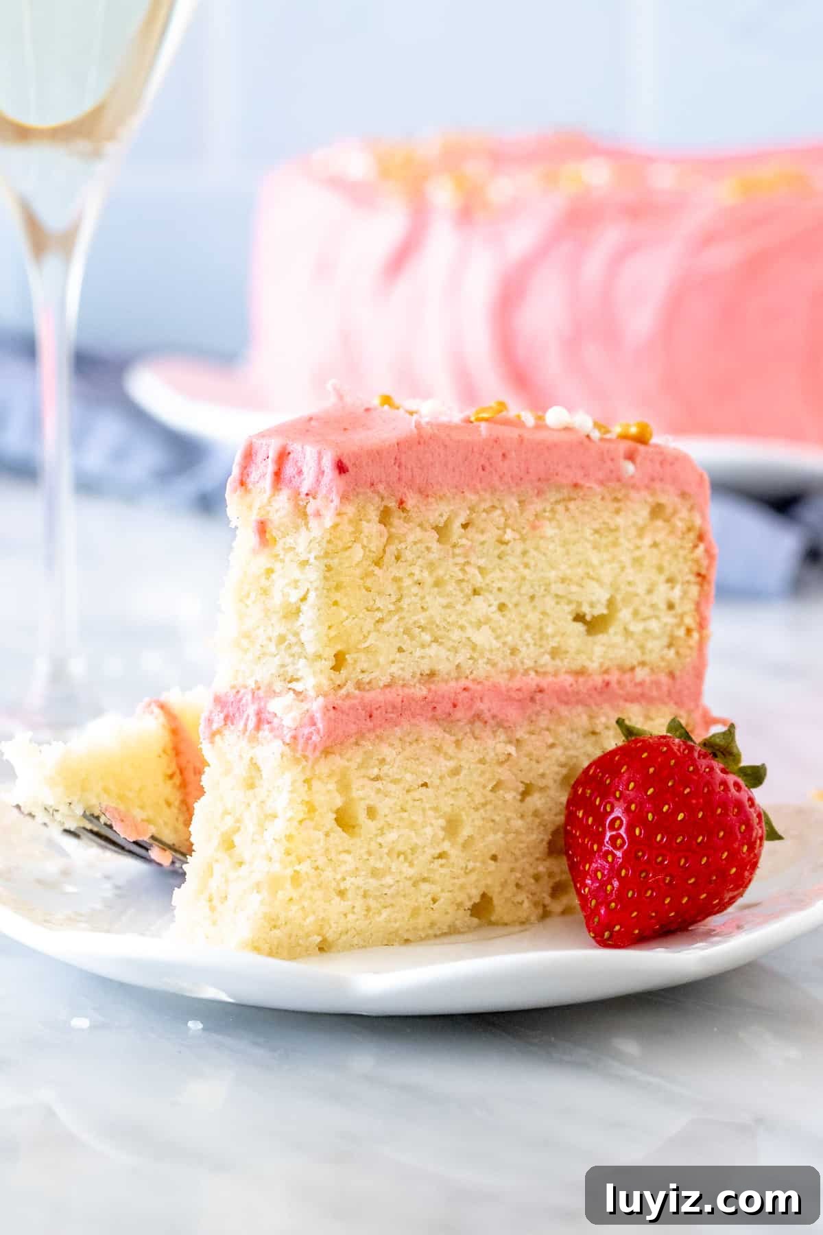 Strawberry Champagne Layer Cake Recipe for Celebrations 6 Slice of cake with pink strawberry frosting