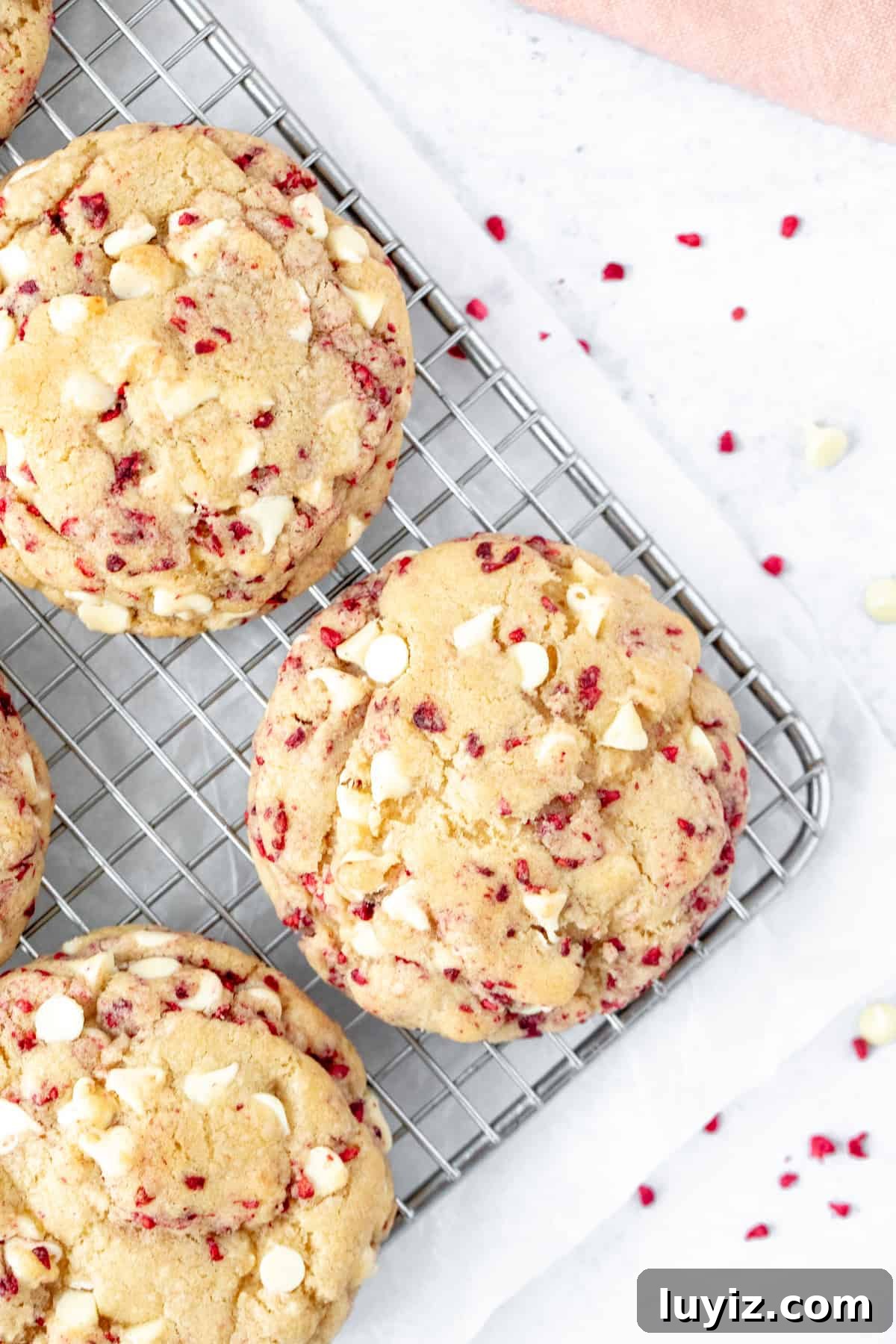 White Chocolate Raspberry Cookie Recipe (Soft & Irresistible) 3 white chocolate raspberry cookies on a cooling rack