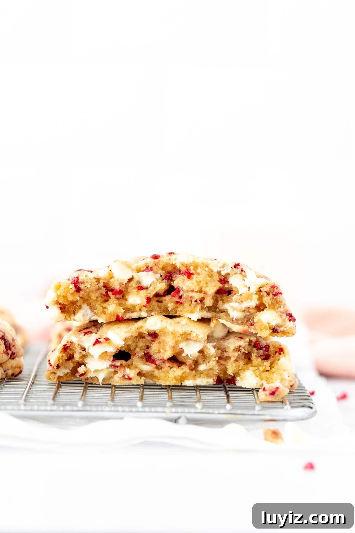 White Chocolate Raspberry Cookie Recipe (Soft & Irresistible) 5 Extra thick white chocolate raspberry cookie broken in half
