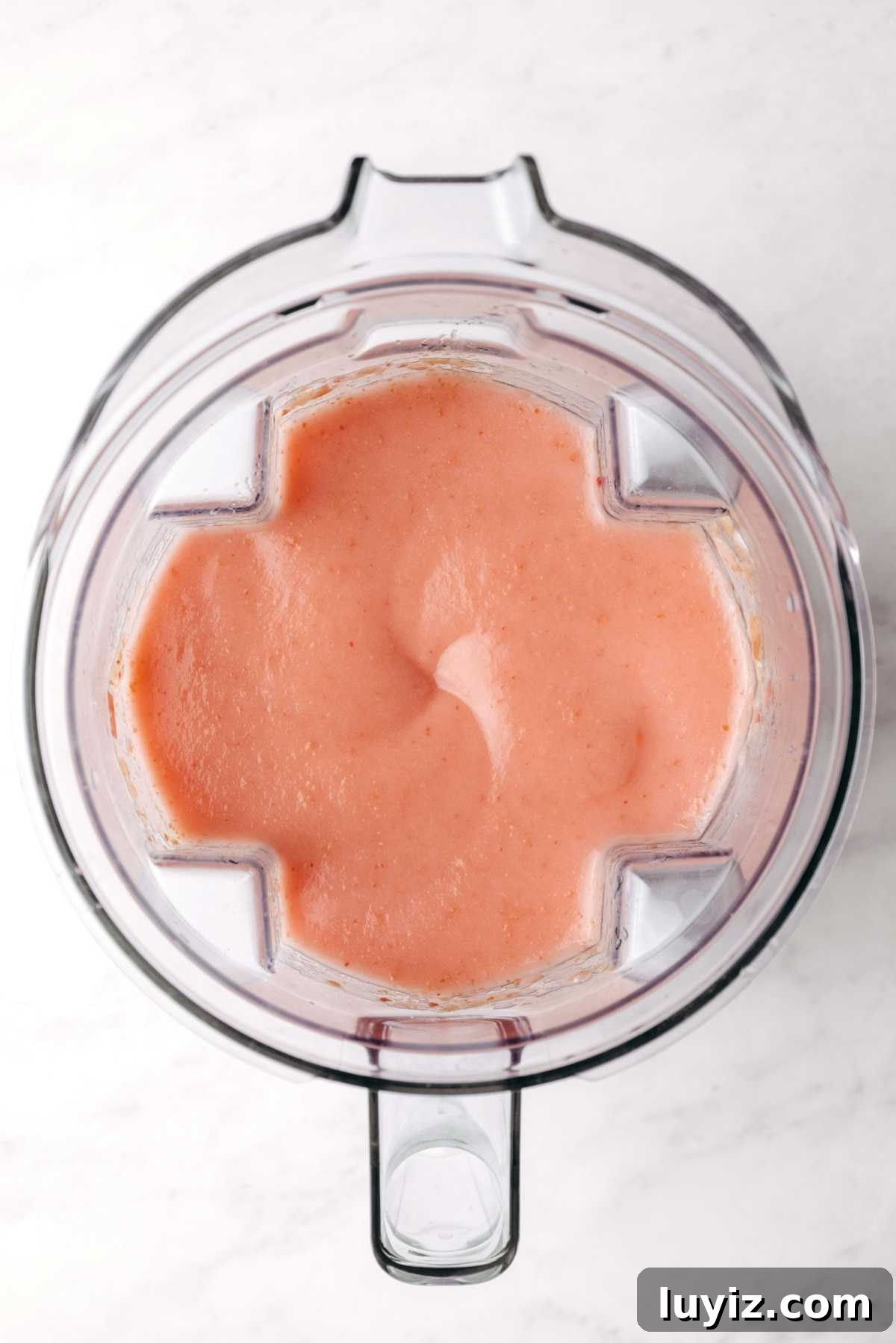 Homemade Applesauce Without Added Sugar: Simple Recipe 8 Blended cortland apples in a blender with the lid off on a white background.