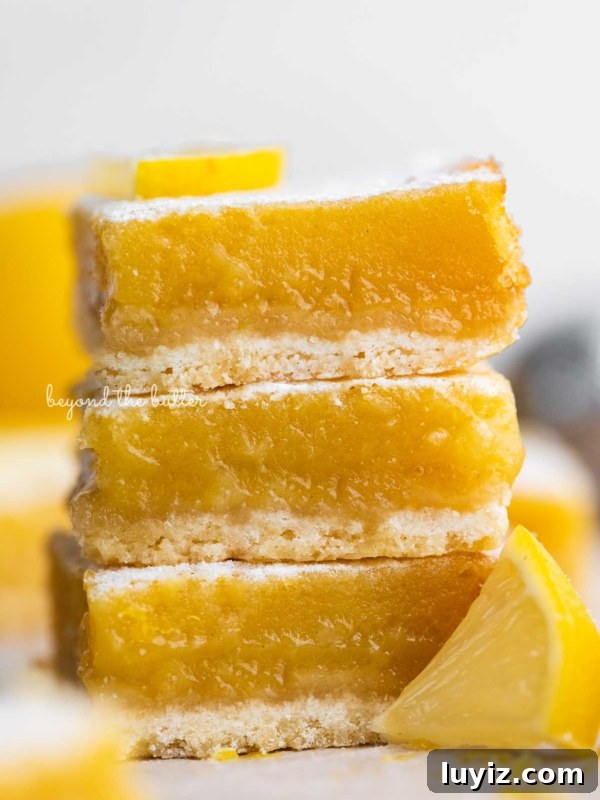 Pumpkin Pie Bars with Creamy Cinnamon Filling 8 Stack of three lemon bars on white background.
