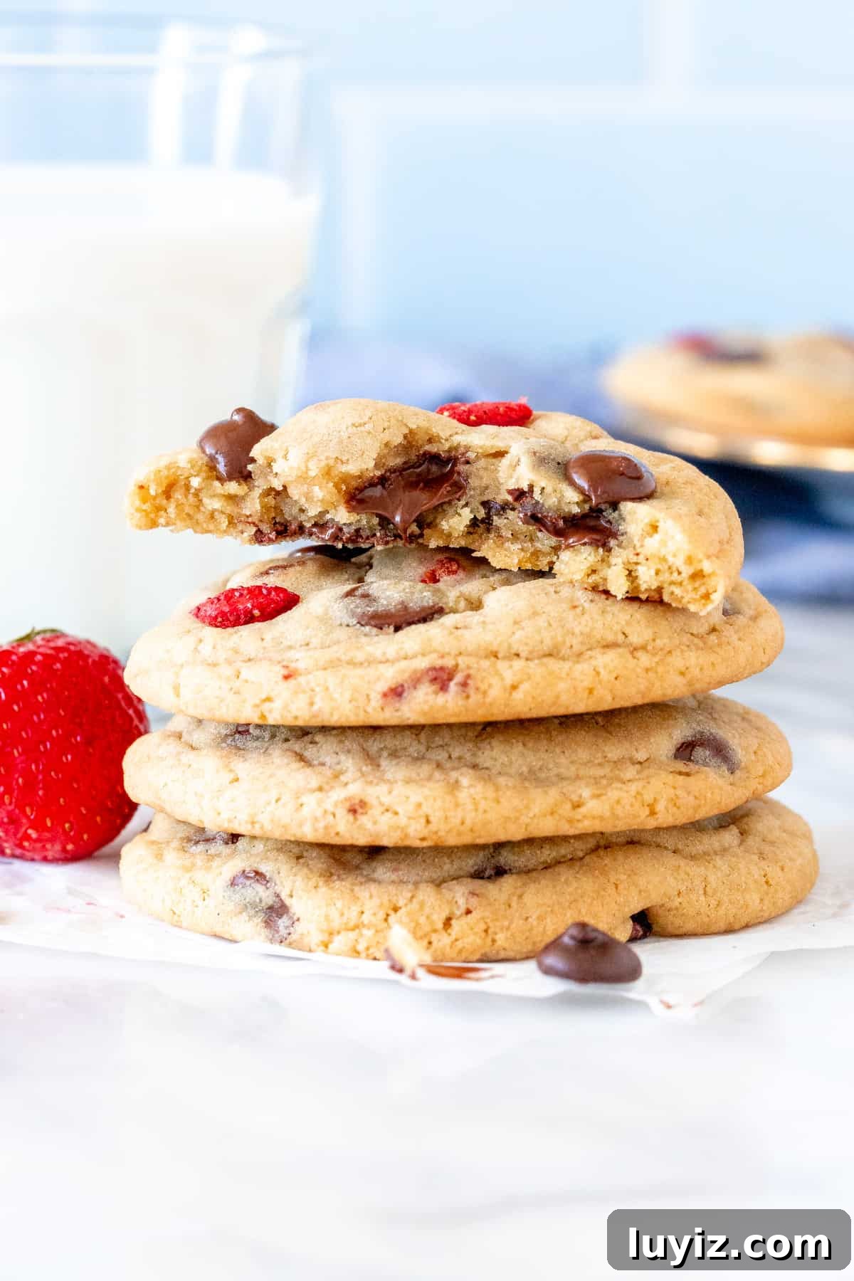 Strawberry and Chocolate Chip Cookie Recipe for Summer Baking 4 Stack of strawberry chocolate chip cookies, with top cookie broken in half