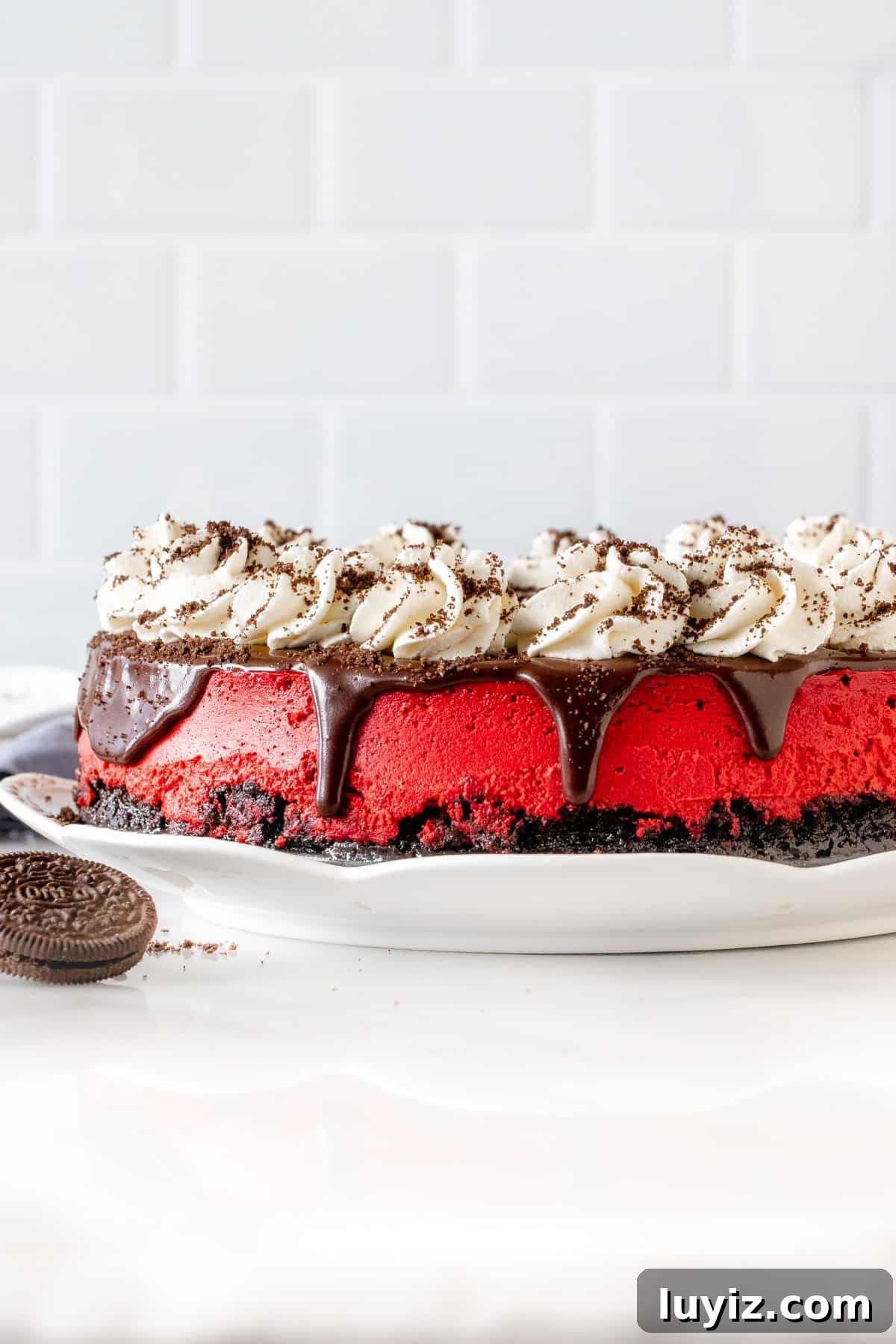 Red Velvet Oreo Cheesecake Recipe with Creamy Chocolate Swirls 3 9-inch round red velvet cheesecake with Oreo crust and topped with chocolate ganache, whipped cream and crushed Oreos