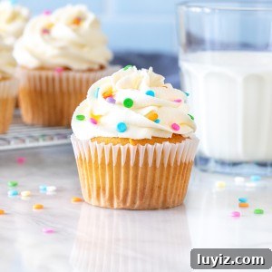 Perfect White Frosting Recipe: How to Make Smooth White Icing 7 Cupcake with bright white frosting and glass of milk
