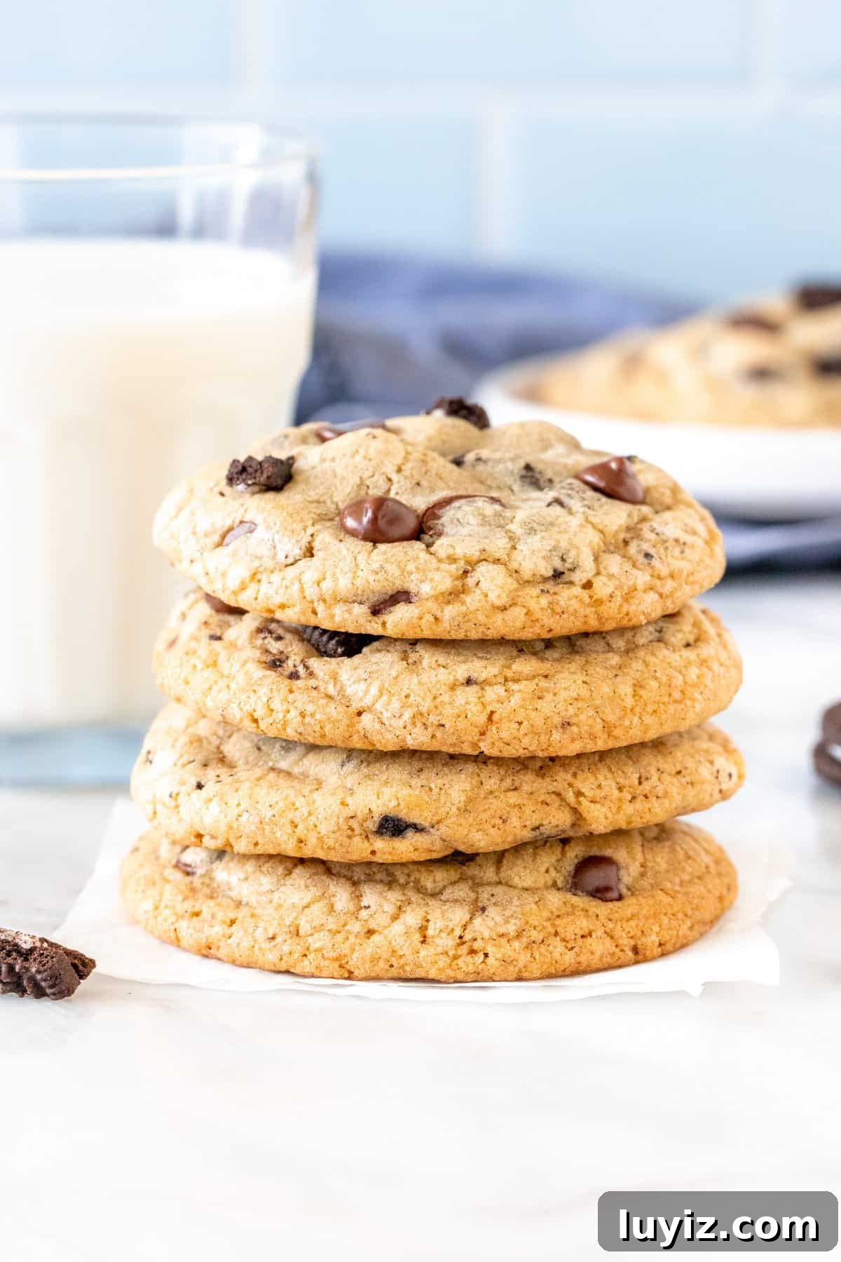 Oreo Chocolate Chip Cookies Recipe — Chewy Cookies with Oreo Pieces 3 4 chocolate chip cookies with Oreo pieces stacked on top of each other.