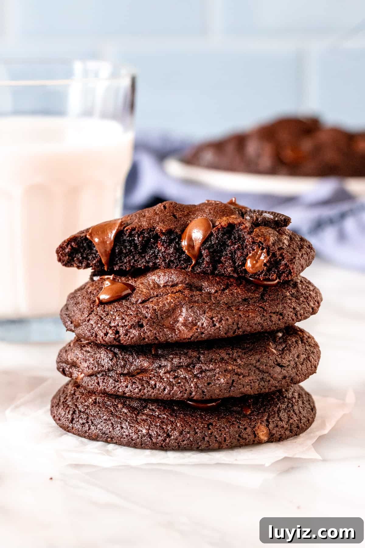 Chocolate Oreo Cookie Recipe: Crispy, Creamy Homemade Treats 6 Stack of chocolate Oreo cookies with the top cookie broken in half.