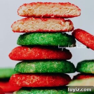 Crispy Almond Sprinkle Cookies — Classic Nutty Sugar Treat 5 Stack of red and green sugared almond sprinkle cookies