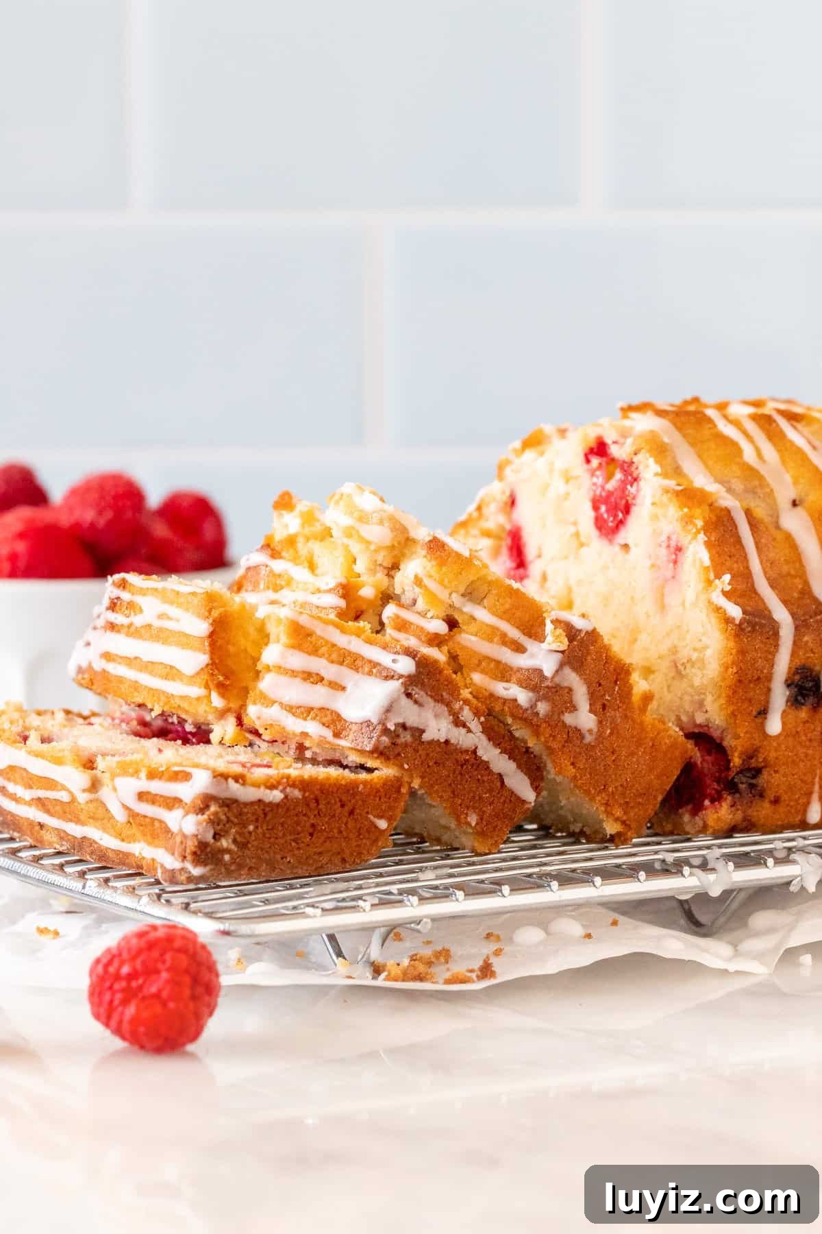 Moist Raspberry Bread Packed with Fresh Berries 2 Raspberry bread with 3 slices cut on a cooling rack