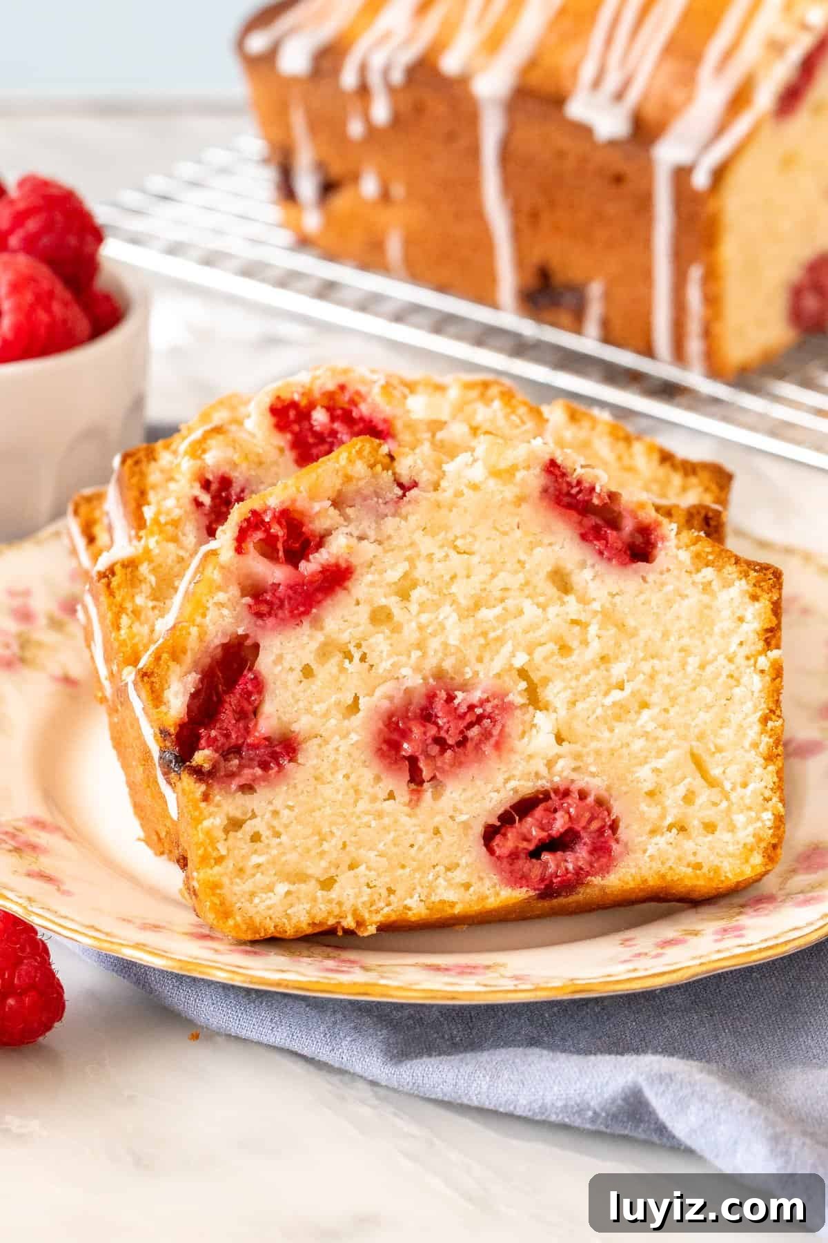 Moist Raspberry Bread Packed with Fresh Berries 4 Slices of moist raspberry bread on a plate