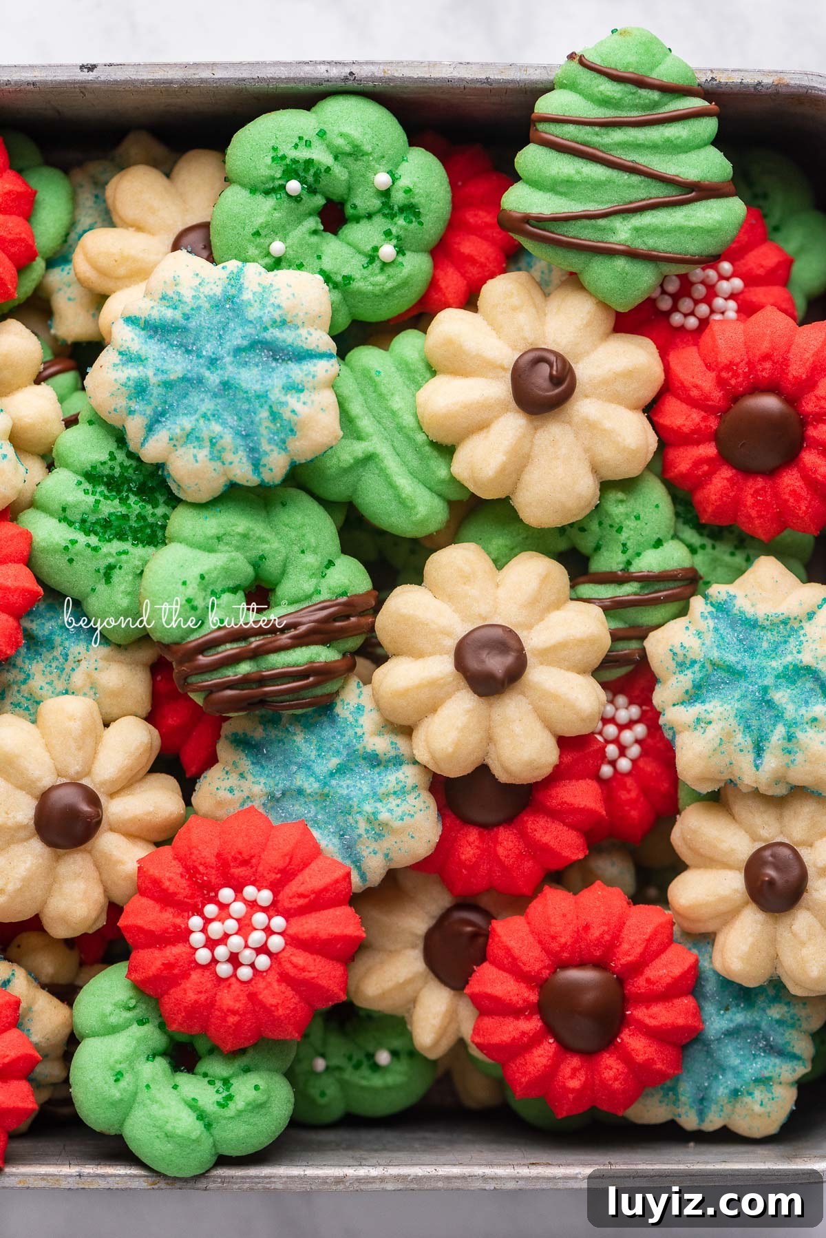 Crisp Butter Spritz Cookies: Traditional Holiday Recipe 5 Pile of classic spritz cookies | © Beyond the Butter®