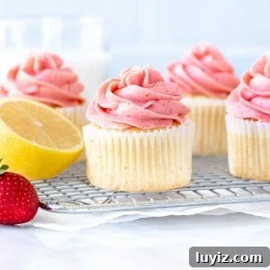 Strawberry Lemonade Layer Cake Recipe — Fresh Summer Dessert 7 Strawberry lemonade cupcakes on a wire rack