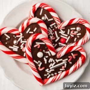 Candy Cane Heart Cookies: Festive Holiday Treats & Gift Ideas 11 Close up of candy cane hearts on dessert plate on white wood background.