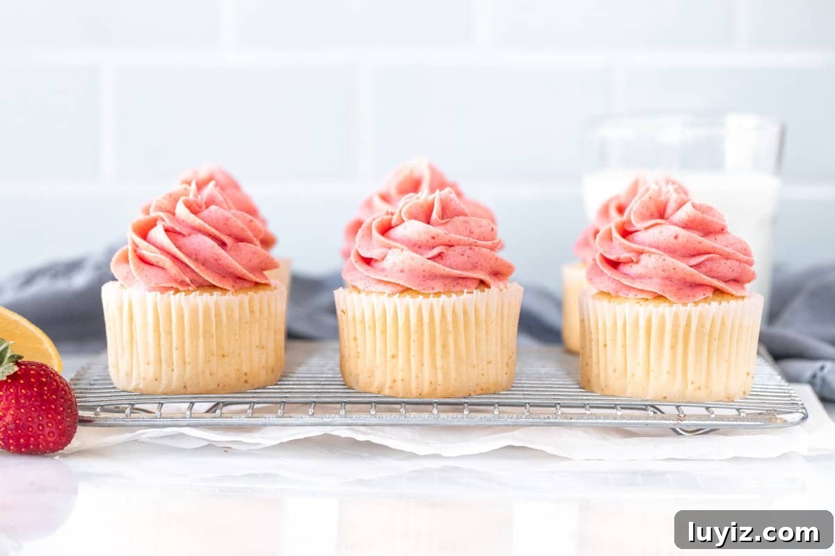 Strawberry Lemonade Cupcakes Recipe with Zesty Lemon Frosting 3 6 lemon cupcakes with strawberry frosting on a wire rack