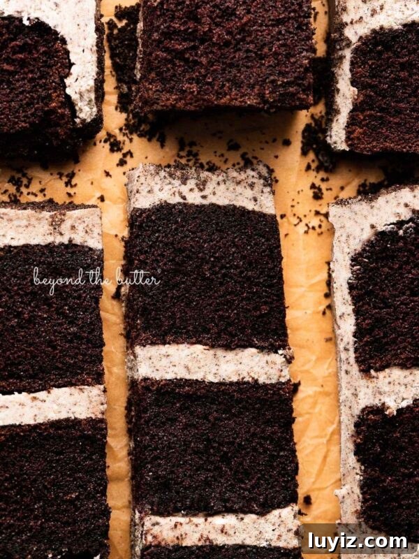 Ultra-Moist Banana Cake Recipe with Cream Cheese Frosting 7 Slices of three layer chocolate cake with oreo buttercream frosting on natural parchment paper.