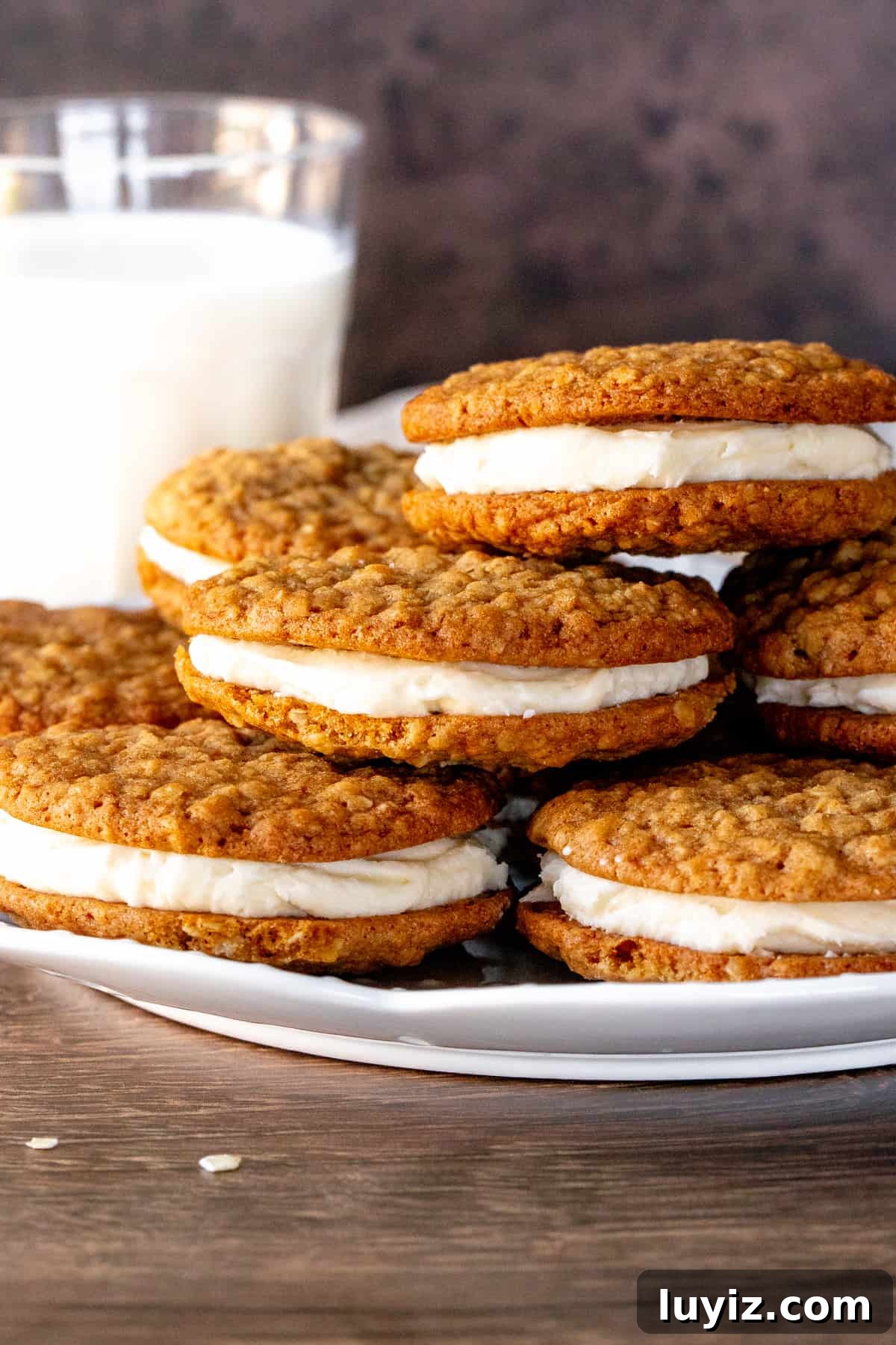 Homemade Oatmeal Cream Pies Recipe — Soft Chewy Oat Cookies Filled With Vanilla Cream 3 Plate of oatmeal sandwich cookies with vanilla frosting