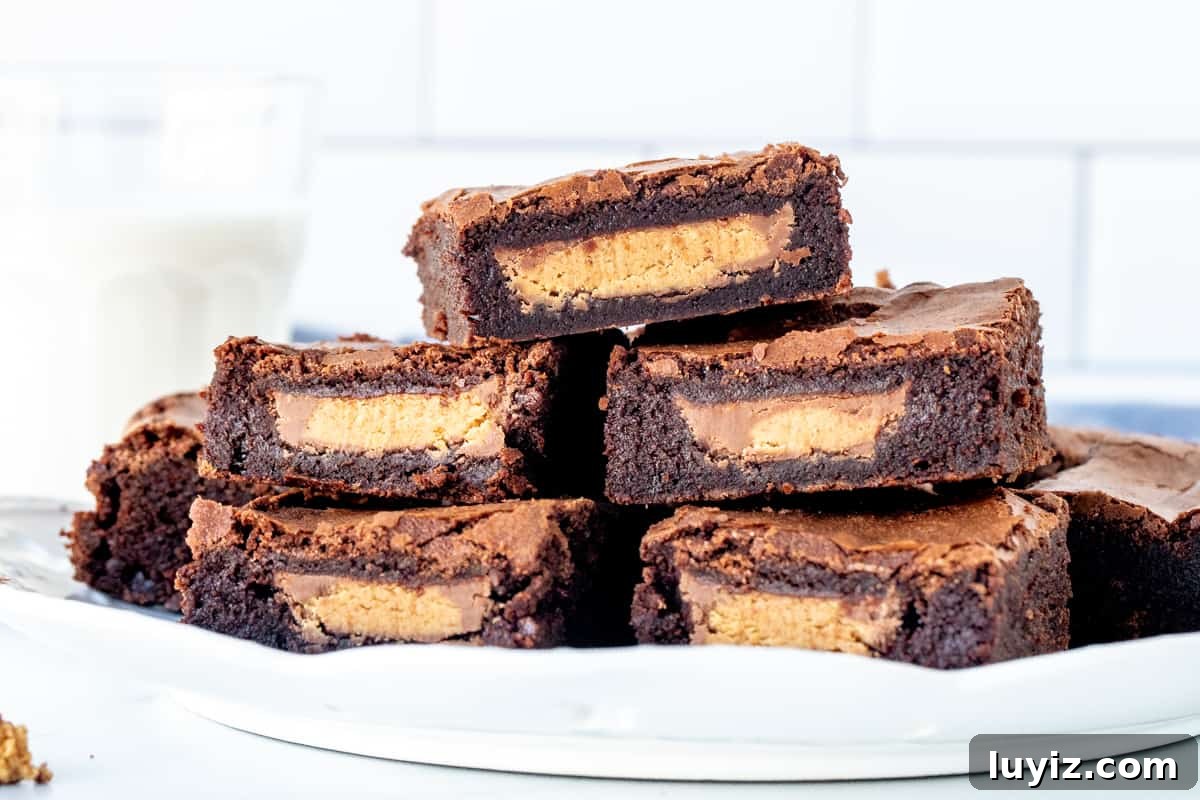 Peanut Butter Cup Brownies Stuffed with Reese's Cups 3 Plate of reese's brownies with a glass of milk