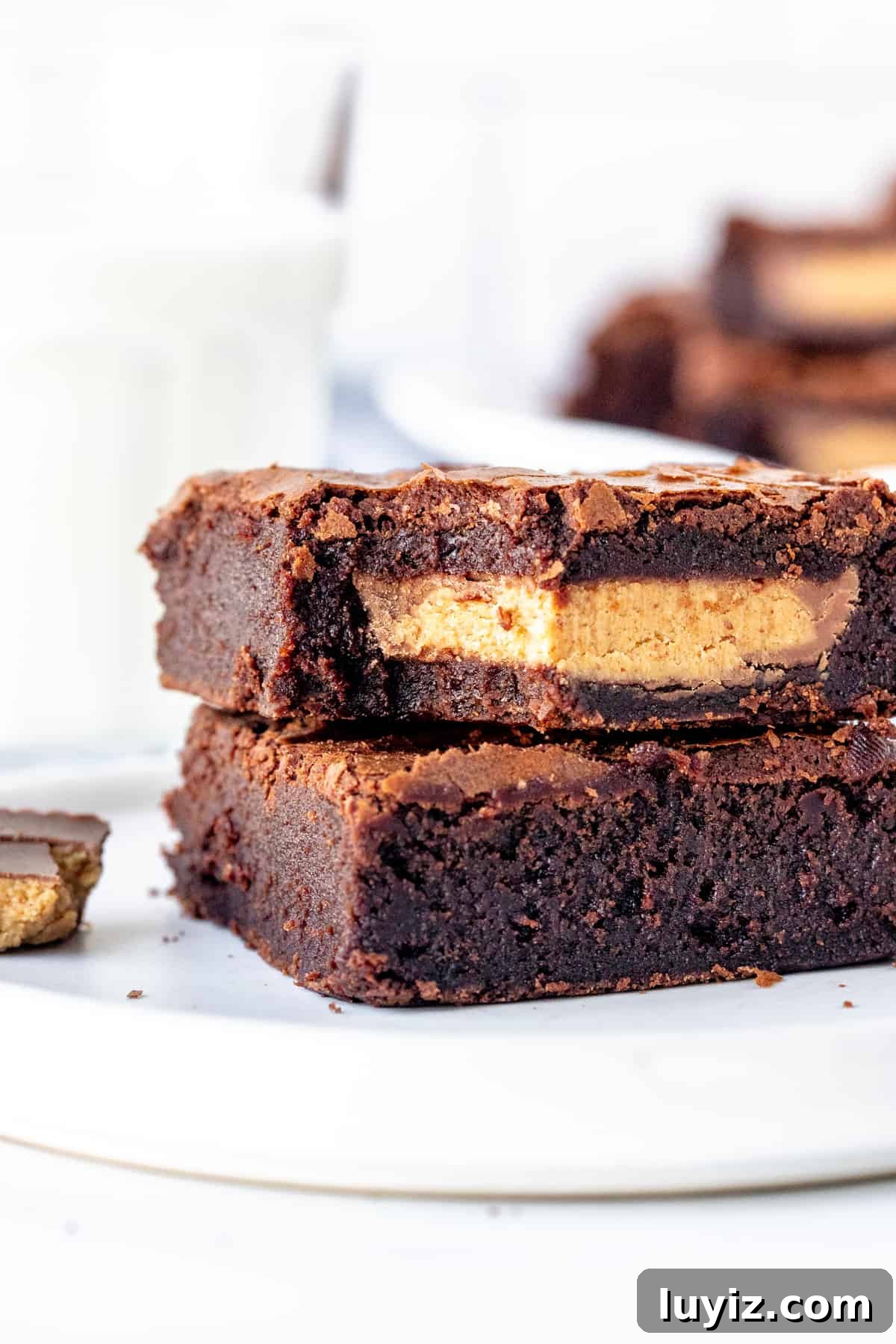 Peanut Butter Cup Brownies Stuffed with Reese's Cups 6 2 peanut butter cup brownies stacked, with a bite out of the top brownie