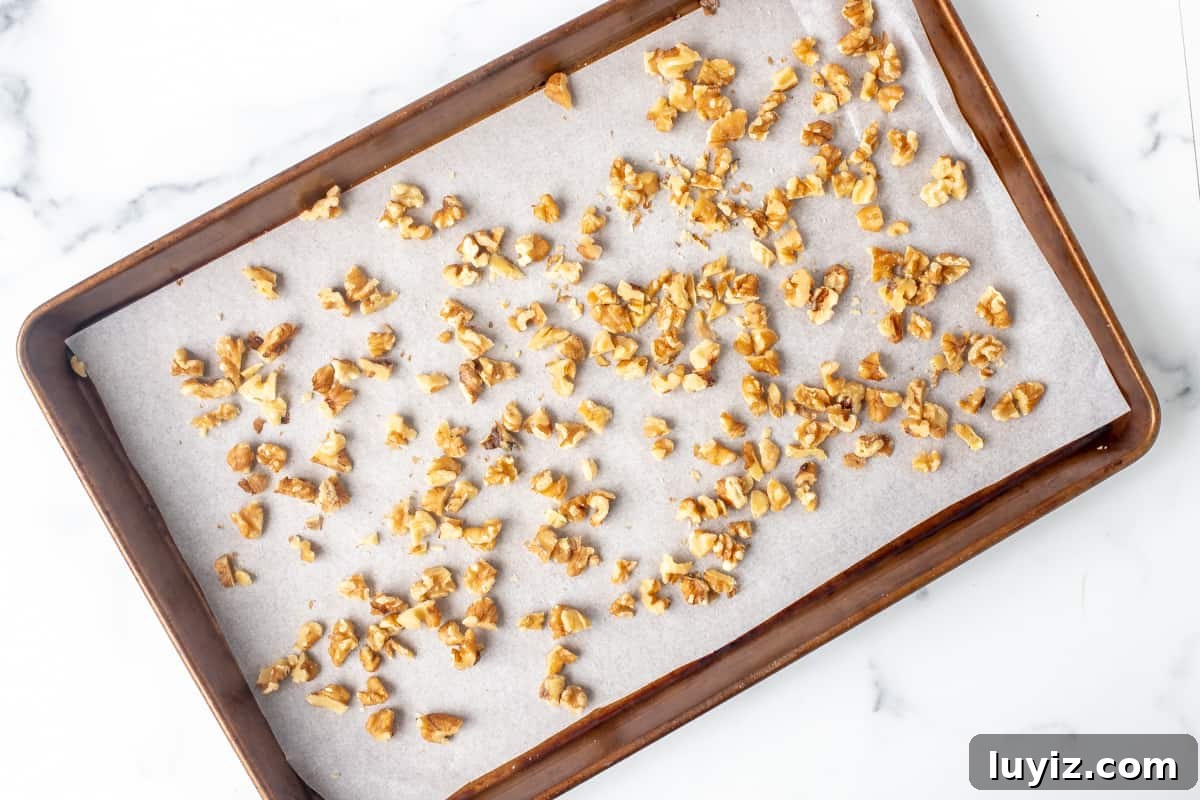Crispy Chocolate Chip Walnut Cookies Recipe for Home Bakers 3 Walnuts on a lined cookie sheet